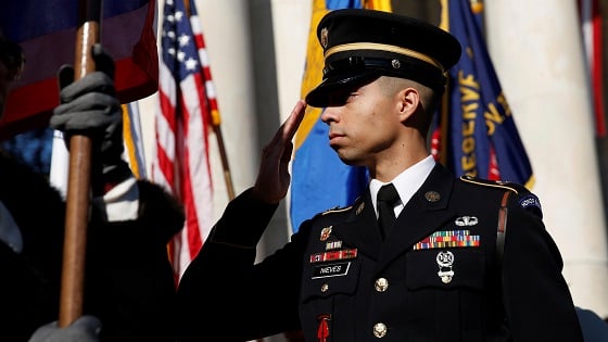 A soldier salutes during ceremonies on Veterans Day at Arlington National Cemetery in Arlington, Virginia