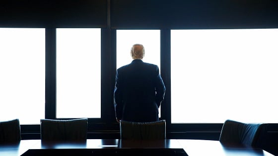 President Trump stands in a conference room