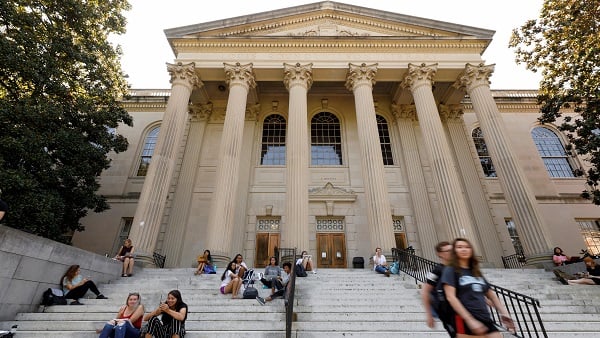 Students sit on the steps of Wilson Library on the campus of University of North Carolina at Chapel Hill.