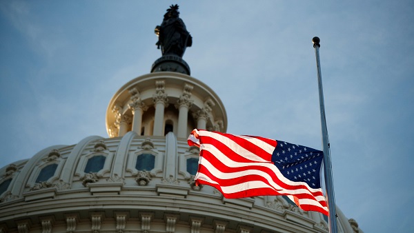 The American flag flies at half staff at the US Capitol in Washington, DC.