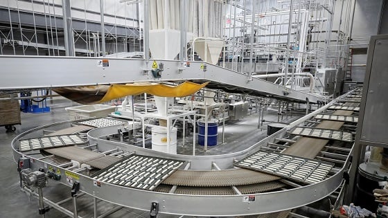 Trays with dough move on an automated line towards the oven during the production process at the Gonnella Baking Company in Aurora, Illinois