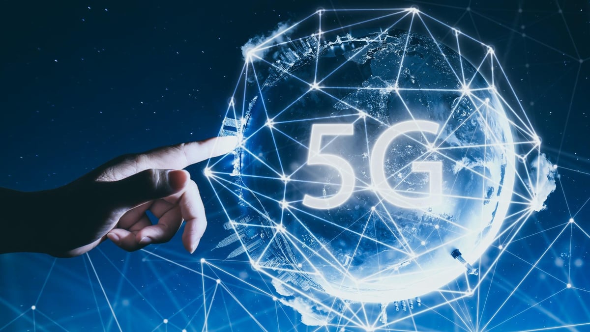 A hand touches an image of 5G network. 