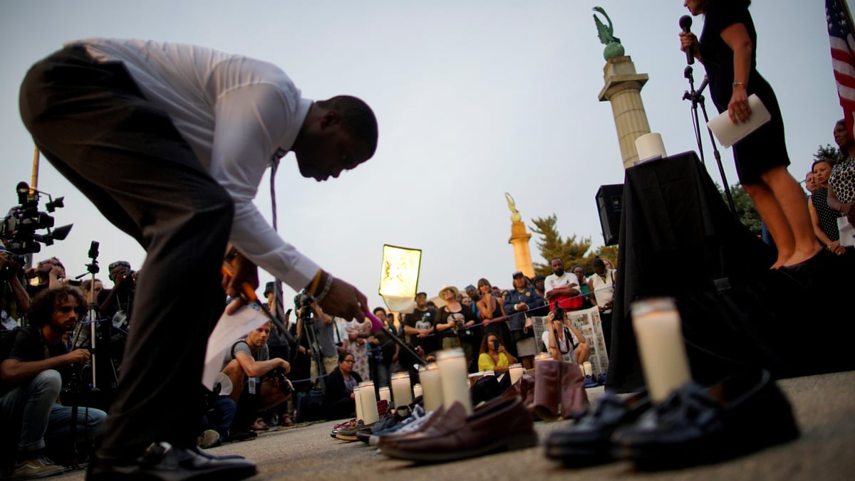 Someone lights candles at a memorial for the El Paso shooting. 