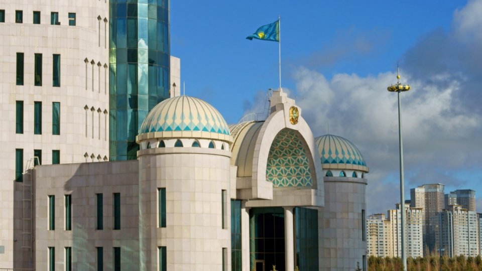 Building with Kazakhstan flag flying near the entrance