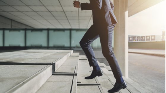 Businessman running fast upstairs