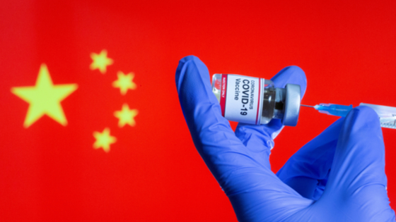 COVID-19 vaccine in front of Chinas flag