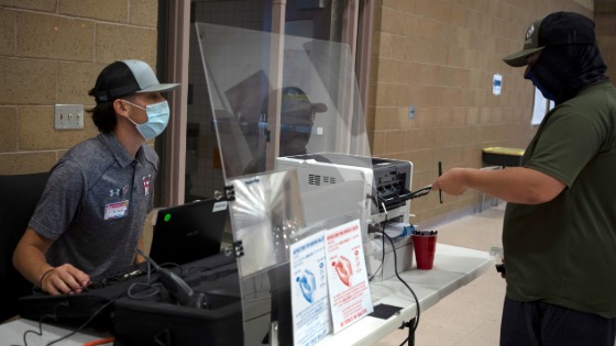 Caleb Kirkland gets his ballot from machine judge