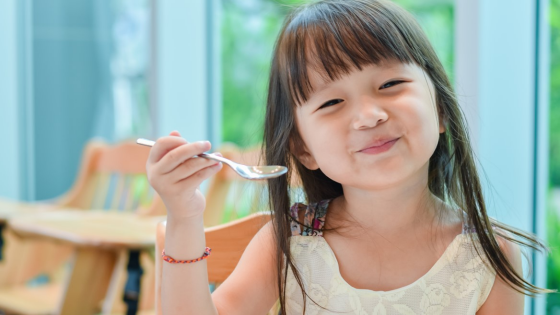 Child eating a bowl of vegetables