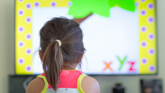 Child watching education program on TV at home