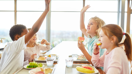 Children eating lunch together at community school