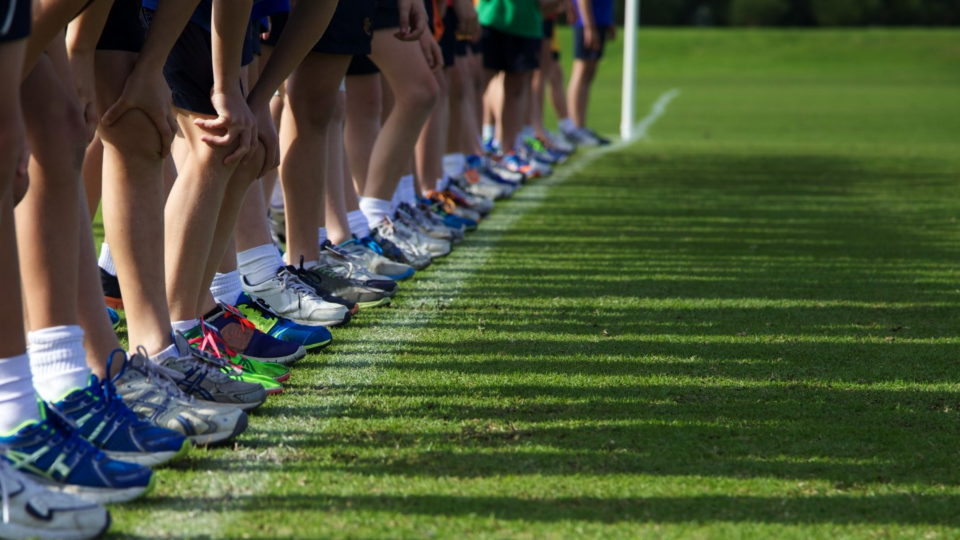 Children lined up for a race on turf