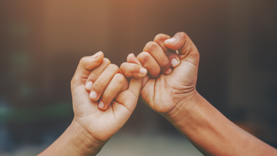 Children linking pinky fingers