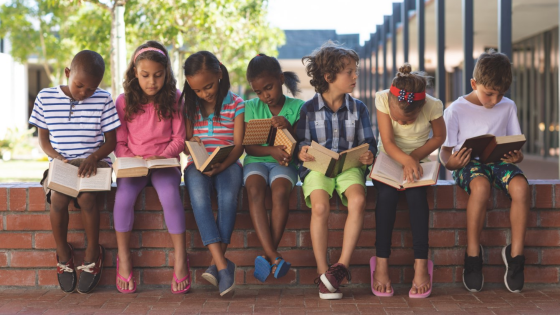 Children reading outside
