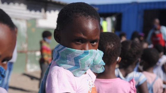 Children wait in line to eat amid the coronavirus crisis in Cape Town