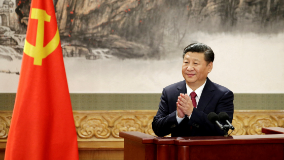 Chinese President Xi Jinping claps after his speech as China's Politburo Standing Committee members meet the press at the Great Hall of the People in Beijing