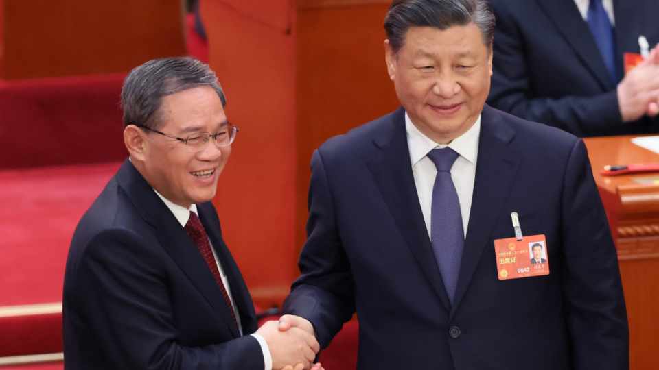 Chinese President Xi Jinping shakes hands with Li Qiang (L), Chinas premier, during the National Peoples Congress in Beijing