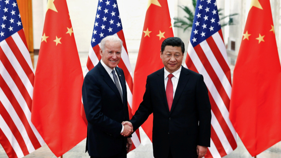 Chinese President Xi Jinping shakes hands with U.S. Vice President Joe Biden inside the Great Hall of the People in Beijing