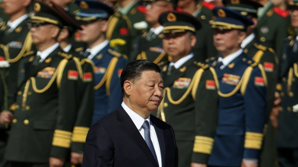 Chinese President Xi Jinping walks past members of the Chinese Peoples Liberation Army as he arrives for a ceremony in Beijing.