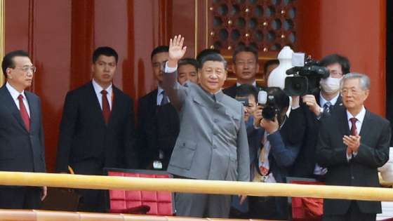 Chinese President Xi Jinping waves next to Premier Li Keqiang and former president Hu Jintao at the end of the event marking the 100th founding anniversary of the Communist Party of China