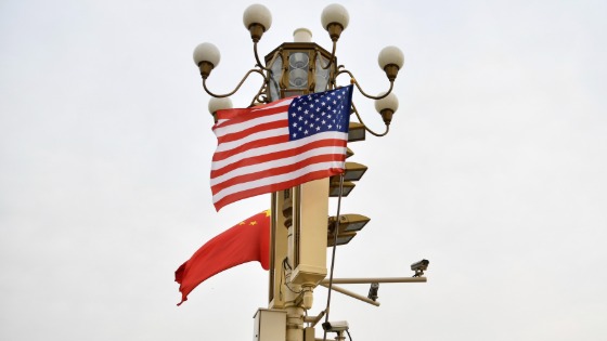 Chinese and American national flags flutter on a lamppost in Beijing festooned with surveillance cameras