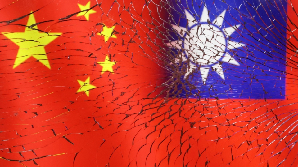 Chinese and Taiwanese flags are seen through broken glass in this illustration