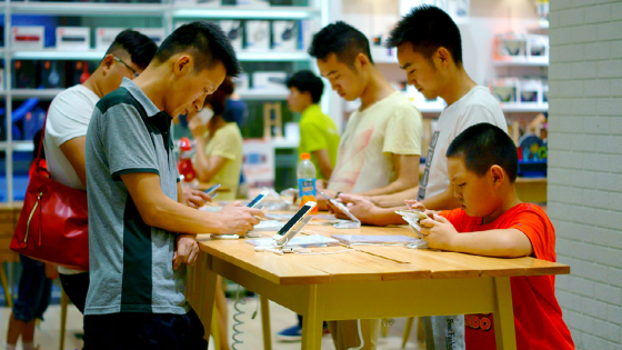 Chinese customers try out Apple smartphones at a store in Yichang city