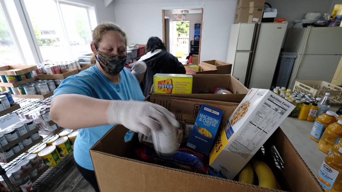 Christy Hagman prepares boxes of food at the C3 Church Food Pantry in Portland