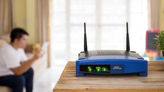 Closeup of a wireless router with person sitting in the background