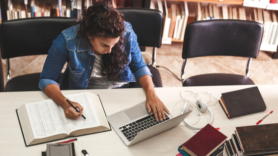 College student completing course work on her laptop