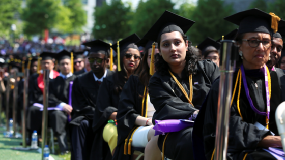 College students sit at graduation ceremony