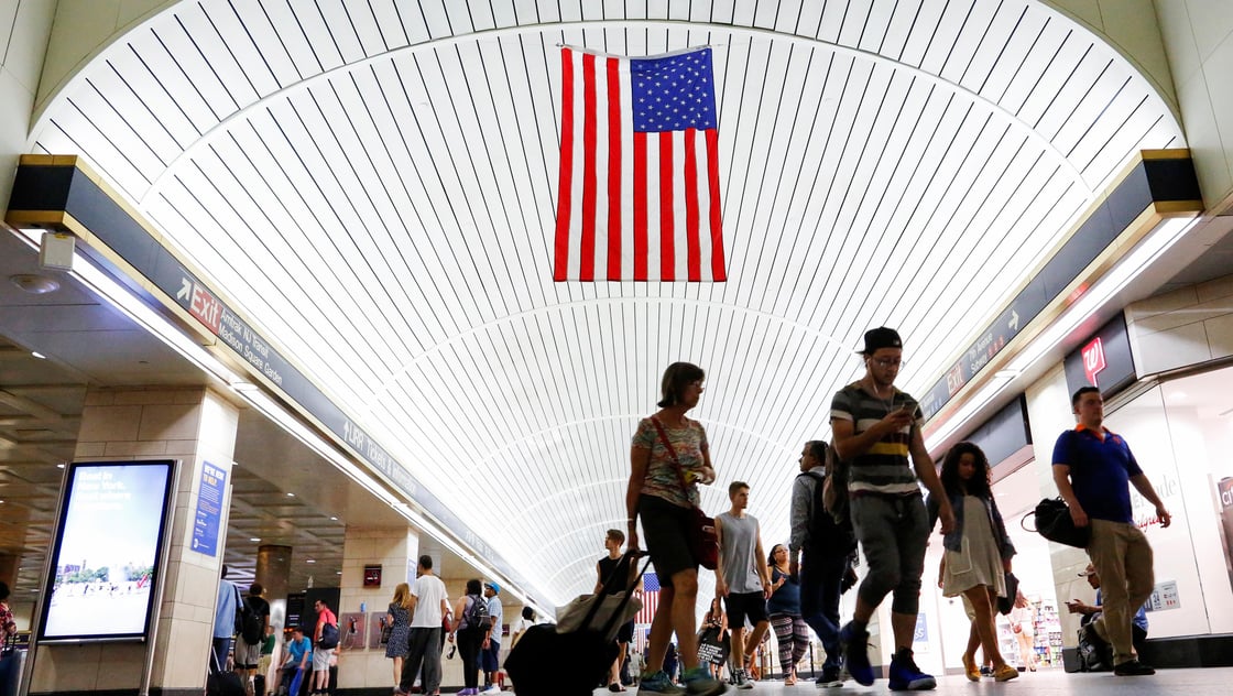 Commuters walk through Pennsylvania Station