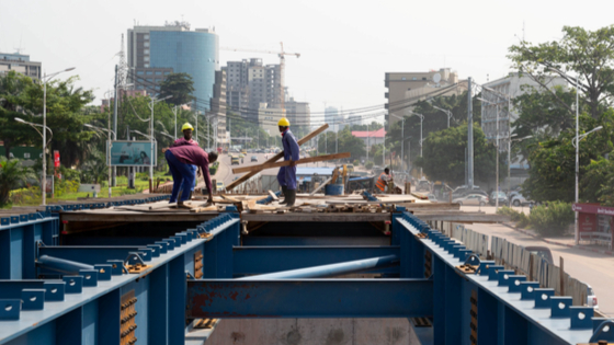 Congolese workers are seen at a construction site for a new overpass dubbed sheep-jumps along a street in Kinshasa