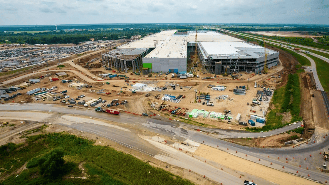 Construction of large warehouse on cloudy day