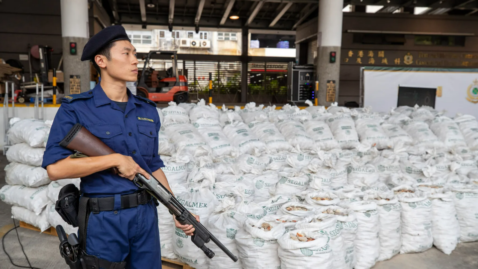 Customs officers guard suspected methamphetamine seized at the Kwai Chung Customhouse Cargo Examination Compound in Hong Kong