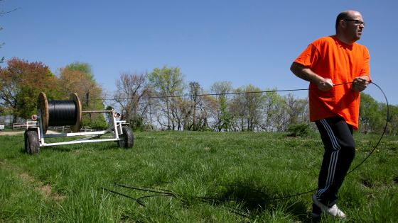 Dave Wallace, owner of Silica Broadband, pulls fiber cable