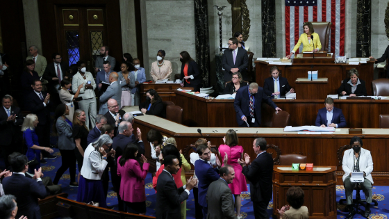 Democratic members of the U.S. House of Representatives applaud and celebrate the House passage of the Inflation Reduction Act