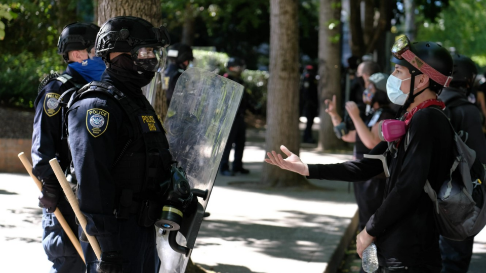 Department of Homeland Security police officers clear Black Lives Matter protesters from Terry Shrunk Plaza in Portland