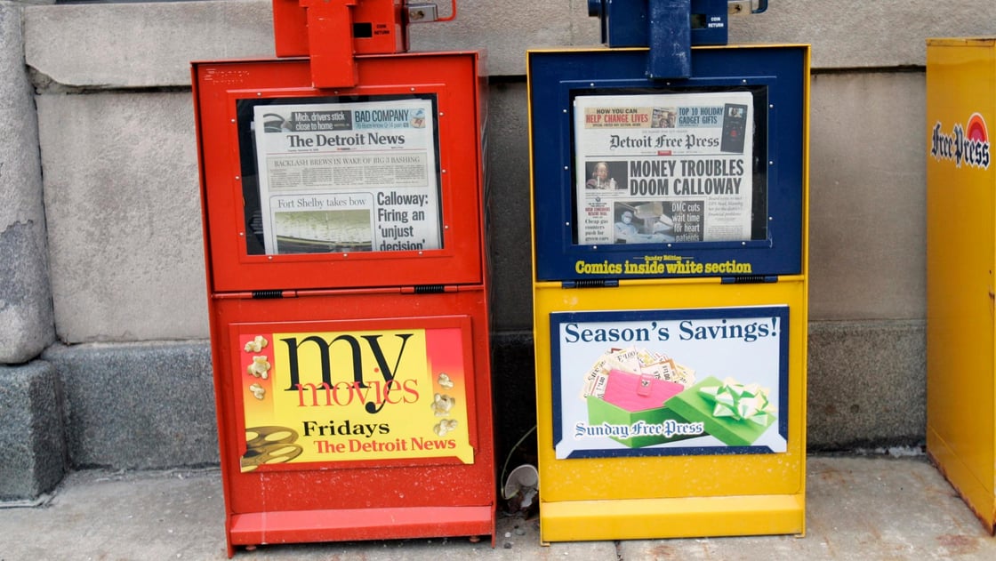 Detroit News and Detroit Free Press paper boxes sit in front of the papers building in Detroit