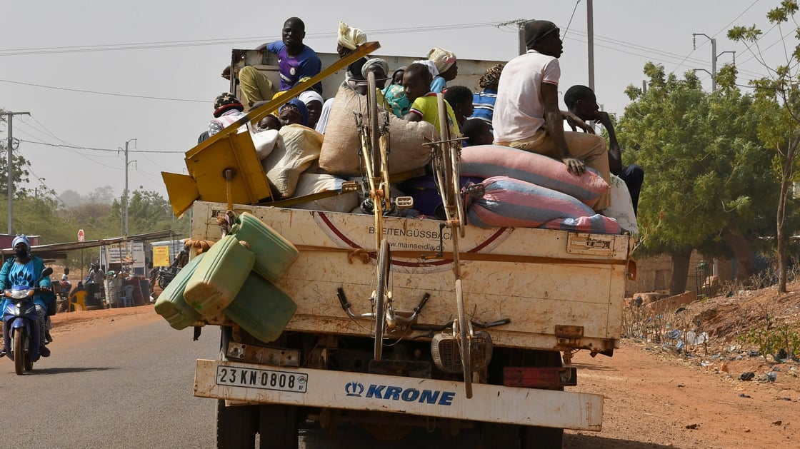 Displaced people who fled from attacks by armed militants in the town of Roffenega arrive on a truck in the city of Kaya near Pissila