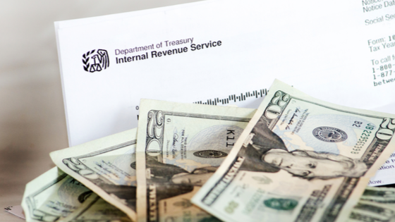 Dollar bills and IRS form