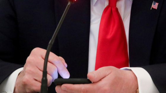 Donald Trump taps the screen on a mobile phone