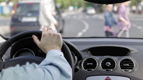 Driver and a pedestrian at a crosswalk