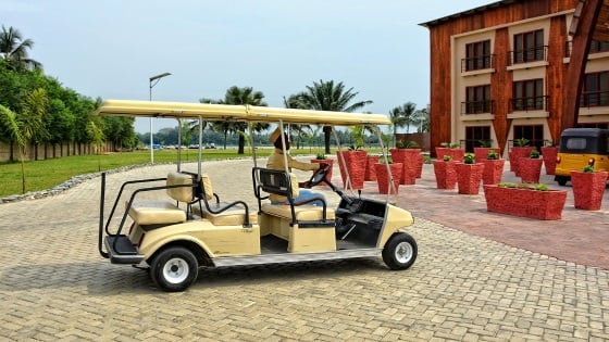 Driver of a Golf Club Car drives to the main building of the Aqua Safari Resort.