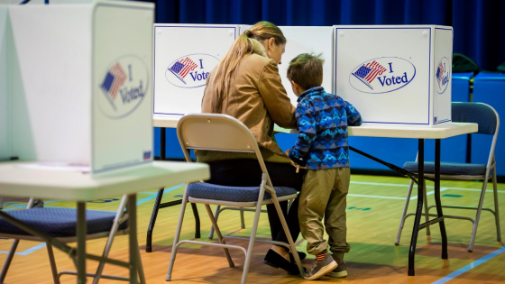 Early voter fills out ballot with son at Lyles-Crouch Traditional Academy in Alexandria