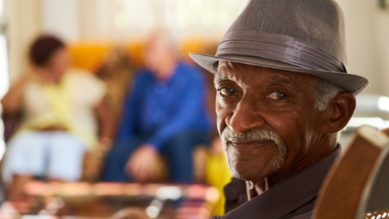 Elderly Black man sitting in chair