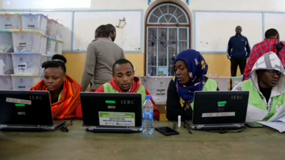 Election officials work on computers at a tallying center in Nairobi, Kenya