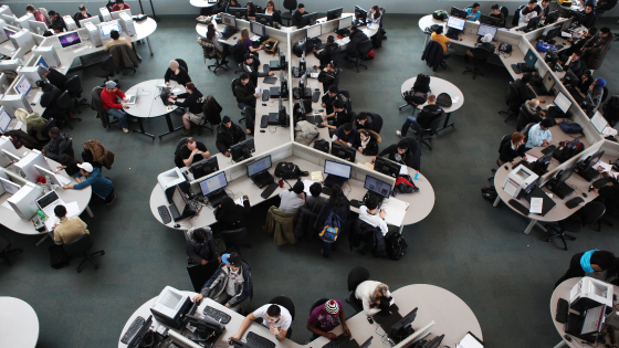 Elevated view of students working in a large college computer lab