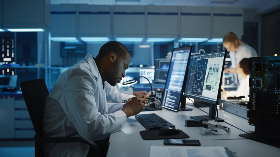 Engineer at his workstation in an electronics development facility