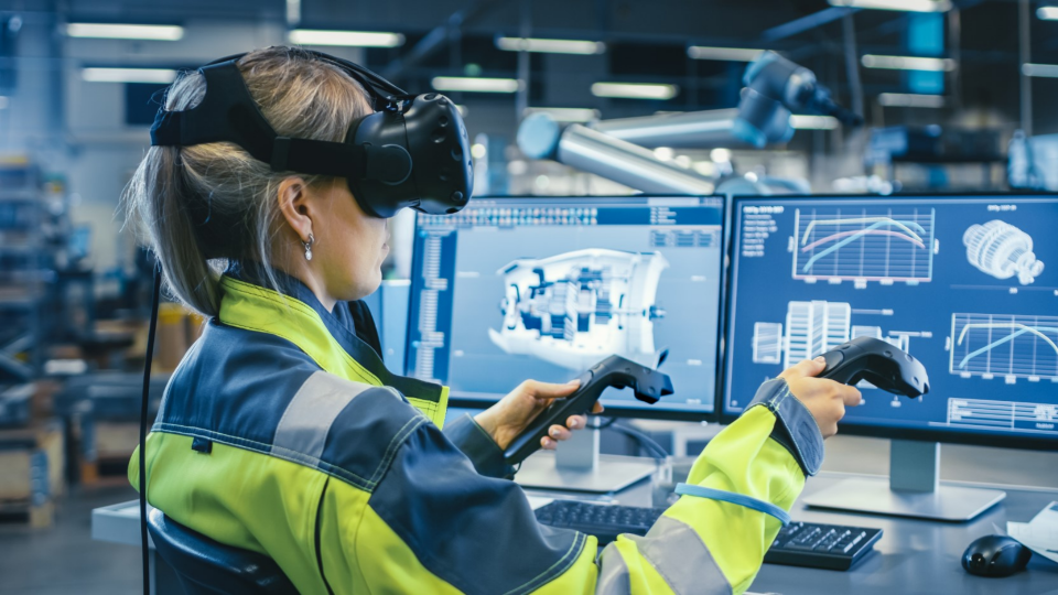 Engineer wearing virtual reality headset and holding controllers