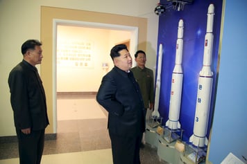 Kim Jong Un (C) provides field guidance at the newly built National Space Development General Satellite Control and Command Centre.